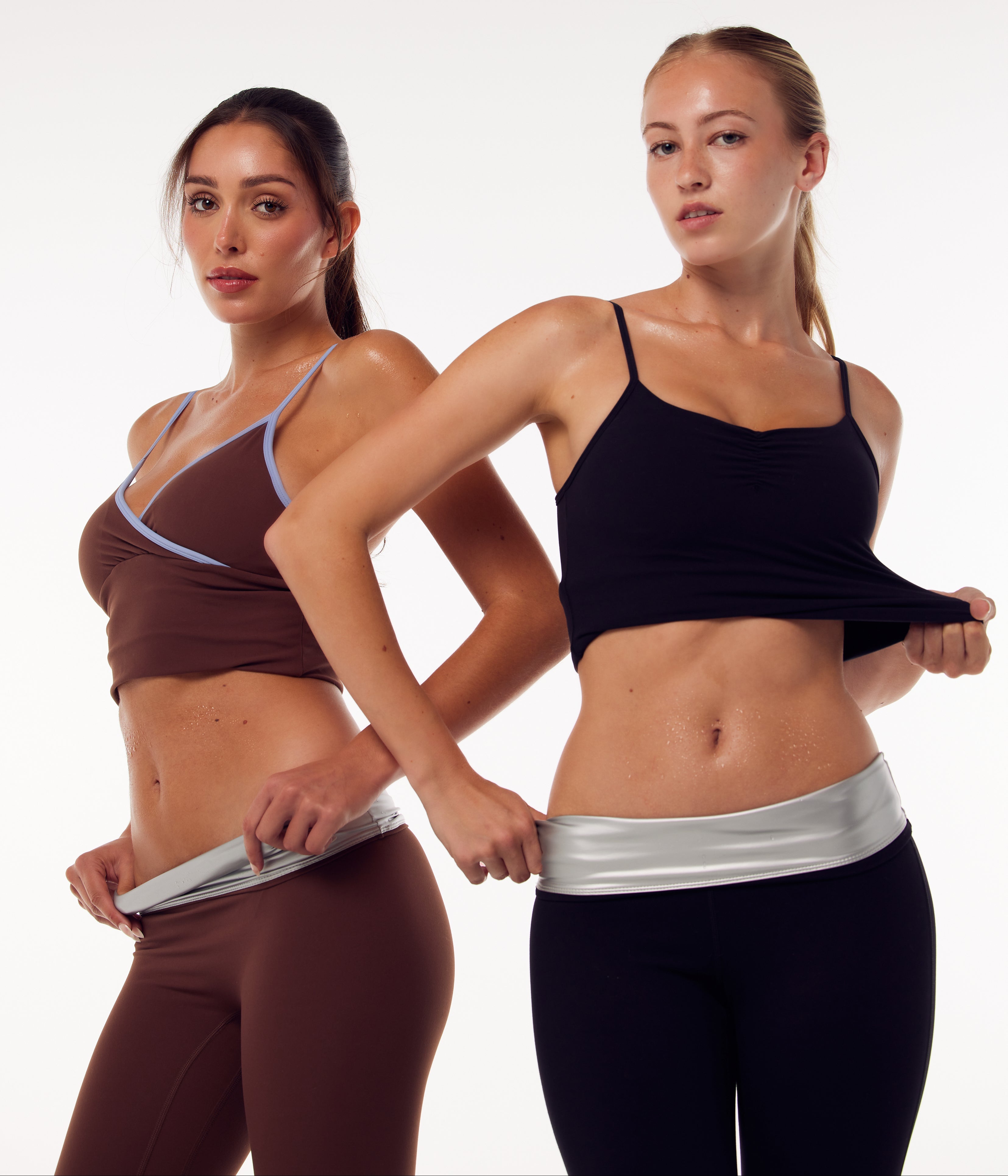 Two women modeling athletic wear against a plain light background. The woman on the left wears a brown sports bra and matching leggings with a light gray waistband.